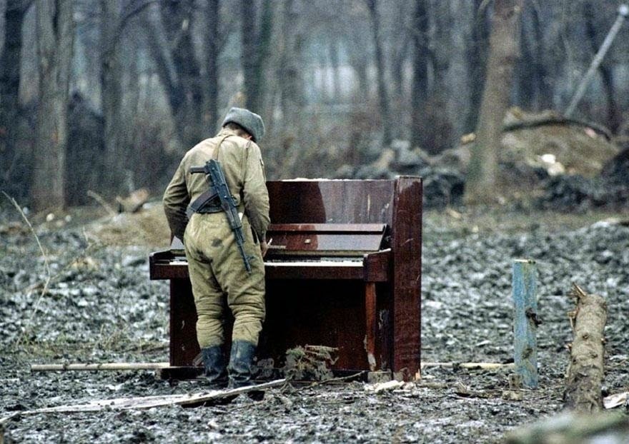 A Russian soldier playing piano in Chechnya in 1994 